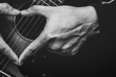 Guitar with fingers shaped like love heart